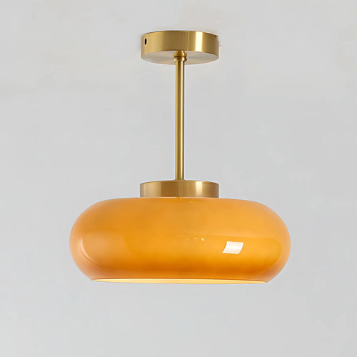 Luna Amber Glass Pendant Light with brushed brass finish on a light gray background.