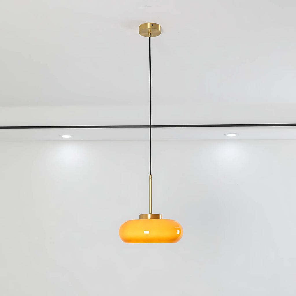 Luna Amber Glass Pendant Light installed above a modern dining table.