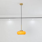 Luna Amber Glass Pendant Light installed above a modern dining table.