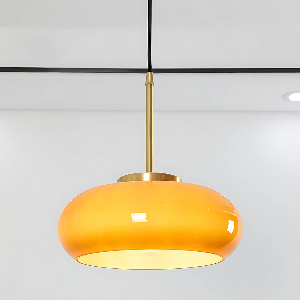 Luna Amber Glass Pendant Light installed above a modern dining table.